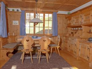a kitchen with a table and chairs and a window at Apartment Drei Tannen by Interhome in Wengen +21 photos