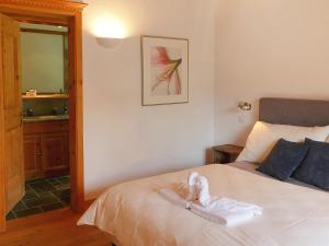 a bedroom with a bed with a towel on it at Apartment Chesa Vadret 12 by Interhome in Pontresina