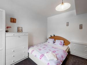 a white bedroom with a bed and a white dresser at Apartment Lanovka-1 by Interhome in Jáchymov