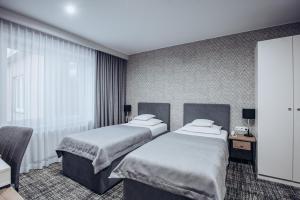 Posteľ alebo postele v izbe v ubytovaní Miejsca noclegowe i Restauracja Kamiński