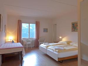 a bedroom with two beds and a window at Apartment Helene Apt-Diana by Interhome in Wengen