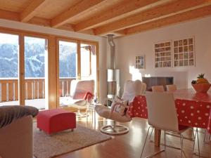 a living room with a table and chairs at Apartment Racer's Retreat-2 by Interhome in Wengen