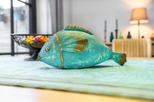 a green fish figurine sitting on a table at Landhaus 1884 OFC 17 in Beiershagen