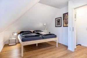 a bedroom with a bed in a attic at Landhaus 1884 OFC 17 in Beiershagen