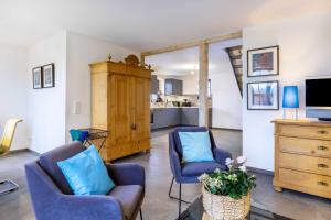 a living room with two chairs and a tv at Landhaus 1884 OFC 17 in Beiershagen +23 photos