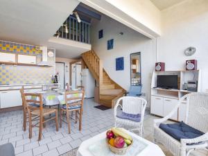 a kitchen and living room with a table and chairs at Apartment Le Florid-7 by Interhome in Cap d'Agde