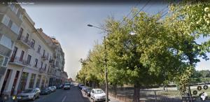 a street with cars parked on the side of the road at Apartment First December in Oradea