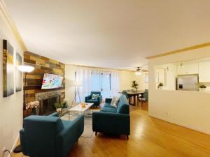 a living room with blue chairs and a fireplace at @ Marbella Lane - 3BR Stylish House near SF in Daly City