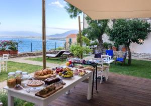 a table with food on it on a deck at Borgo Dei Saraceni - Suites & Apartments in Agropoli