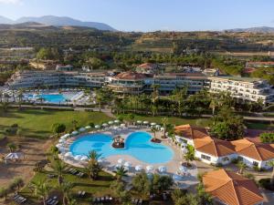 a large swimming pool in a large city at Grand Palladium Sicilia Resort & Spa in Campofelice di Roccella