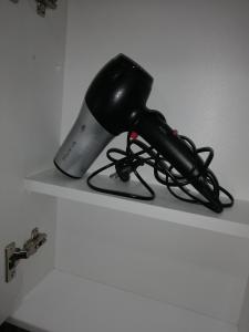 a blow dryer sitting on top of a shelf at Apartmani ANTEL 5* in Banja Koviljača