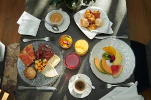 a table with two plates of breakfast foods and coffee at Acta Splendid in Barcelona