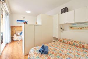 a bedroom with a bed and a room at Appartamenti Di Edo in Finale Ligure