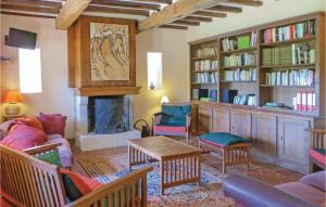 a living room filled with furniture and a fireplace at Awesome Home In Domfront En Champagne With Wifi, Outdoor Swimming Pool And Heated Swimming Pool in Domfront-en-Champagne
