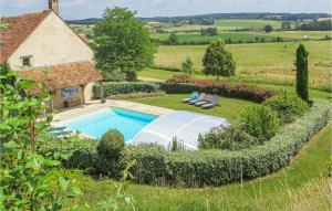 a garden with a swimming pool and a house at Awesome Home In Domfront En Champagne With Wifi, Outdoor Swimming Pool And Heated Swimming Pool in Domfront-en-Champagne