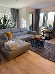 a living room with a couch and a table at Apartment-47 Fulda in Petersberg