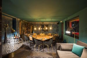 a dining room with a long table and chairs at Super G in Courmayeur