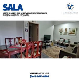 a picture of a living room with a table and chairs at Casa com piscina, churrasqueira, 3 suítes com ar condicionado in Caldas Novas