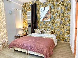 een kleine slaapkamer met een bed en een muur bij Art Apparts coeur de ville in Béziers