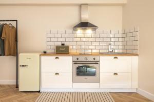 a kitchen with white cabinets and a stove at K-Houses A1 in Arta