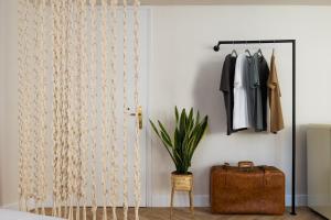 a room with a door with a suitcase and a closet at K-Houses A1 in Arta +8 photos
