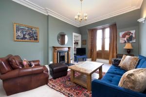 a living room with a couch and a table at JOIVY Old Town 1-Bed Apartment with Stunning Views in Edinburgh
