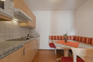 a kitchen with a table and a counter top at Regina's Residenz in Sölden