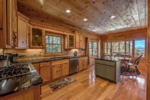 a kitchen with wooden cabinets and a table and chairs at Rudy's Retreat in Ellijay