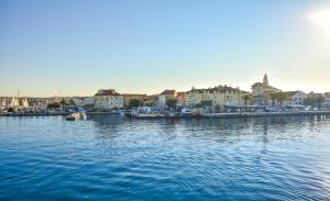 a large body of water with buildings and houses at Apartment Songbird in Biograd na Moru