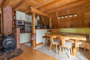 a kitchen with a wooden table and a stove at Villa Teodora in Kopaonik