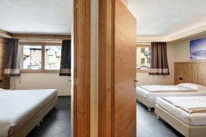 Posteľ alebo postele v izbe v ubytovaní Rasia Residence Relax Lake