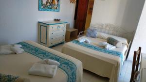 Postel nebo postele na pokoji v ubytování Hotel Canne al Vento