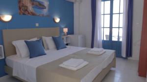 Postel nebo postele na pokoji v ubytování Bluu Bahari Hotel