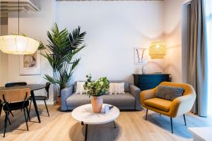 a living room with a couch and chairs and a table at The Beach apartments by Daniel&Jacob's in Copenhagen