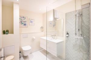 a bathroom with a toilet and a sink and a shower at The Beach apartments by Daniel&Jacob's in Copenhagen