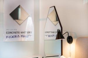 a living room with a mirror and a lamp at The Beach apartments by Daniel&Jacob's in Copenhagen