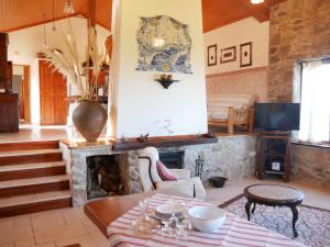 a living room with a table and a fireplace at Pines of Salgado beachview villa by Book YourHoliday PT in Nazaré