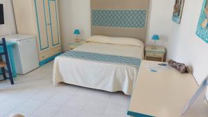 Postel nebo postele na pokoji v ubytování Hotel Canne al Vento