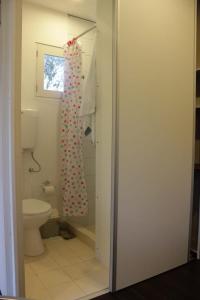 a bathroom with a toilet and a shower curtain at Rincon del Diario in Punta del Este