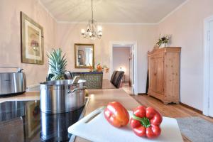 a kitchen with tomatoes on a cutting board on a counter at Villa Magdalena 05 in Ahlbeck