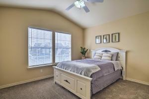 a bedroom with a bed and a ceiling fan at Walk to Grand Lake Modern Afton Townhome! in Afton