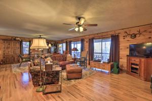 a living room with a couch and a ceiling fan at Lakefront Sparta Cottage with Decks and Boat Dock in Sparta