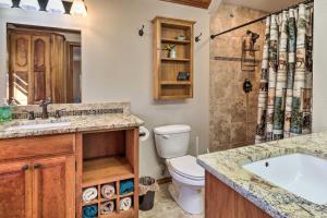a bathroom with a tub and a toilet and a sink at Welcoming Cañon City Abode - Walk to River! in Canon City +21 photos