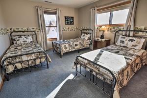a bedroom with two beds and a chair and a window at Welcoming Cañon City Abode - Walk to River! in Canon City
