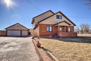 a brick house with a garage in a yard at Welcoming Cañon City Abode - Walk to River! in Canon City
