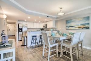 a kitchen and dining room with a table and chairs at Condo with Spacious Balcony - 1 Block to Beach! in Ocean City