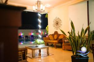 a living room with a couch and a table at The Ocean Pearl Hotel Negombo in Negombo