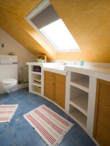 a bathroom with a sink and a skylight at Ferienwohnung Maxima in Weiskirchen +24 photos