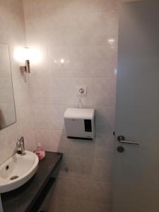 a bathroom with a sink and a toilet and a shower at NUVOLA Summer Spring in Zottegem +10 photos