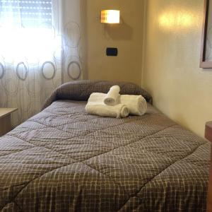 un animal de toallas sentado en la parte superior de una cama en Residence Oasi Di Monza, en Monza